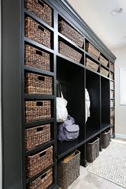 White wood bench with wicker baskets and wood headboard with metallic hangers. Mudroom Flooring Do S And Don Ts For Lasting Durability And Good Looks Normandy Remodeling