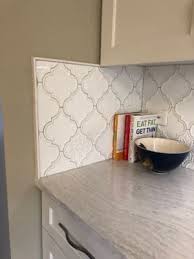 This attractive tile features arabesque patterned pieces of glazed porcelain mesh sheet that makes installation a much easier process. Byzantine Arabesque Bianco Ceramic Wall Polished Mosaic Tile Arabesque Tile Backsplash Kitchen Kitchen Remodel Arabesque Tile Backsplash
