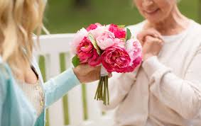 How to do flowers for a wedding/event. Daughter Giving Flowers To Senior Mother At Park Living On The Cheap