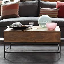 This coffee table from west elm fuses the industrial with the rustic, made from solid mango wood with a blackened steel frame. Rustic Storage Coffee Table Basically Beautiful Furniture Storage Organizing