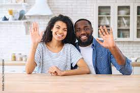 Video chat with an African-American couple, cheerful biracial woman and man  looking at the camera and waving hello. Virtual meeting with family or  friends, video call during pandemic, webcam view Stock Photo |