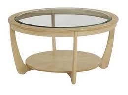 Modern spaces are really an attempt an upholstered coffee table that doubles as an ottoman is a fresh look that exudes comfort and casual luxury. Nathan Shades Oak Glass Top Round Coffee Table Coffee Tables Hafren Furnishers