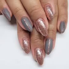 Two of the nails are covered in gold glitter. 35 Gorgeous Rose Gold Nails Perfect For Any Event 2021 Guide