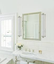 This standard design bathroom by perkison residences includes a stylish round bevelled mirror that contrasts the square angles of the vanity. The Right Way To Use Bathroom Sconces Design Inspirations Lightsonline Blog