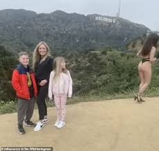 Awkward moment a family photo is ruined by nearly-nude woman posing next to  them | Daily Mail Online