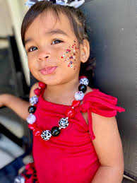 Rocking minimal makeup, layered necklaces, and a Reba hoodie.
