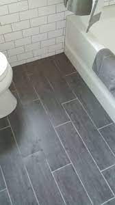 My Finished Bathroom Floor Grey Porcelain Bamboo 6x24 Staggered Layout Light Grey Grout Bathroom Flooring Bathroom Remodel Shower Gray Tile Bathroom Floor