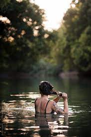 Young Woman Swimming In Creek And Wringing Out Her Hair By Jack Sorokin Lake Photography Swimming Pictures Swimming Photography