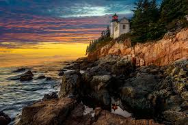 The trail from the parking lot leads to the lighthouse and rocky shore from where you get a good view of both the light house and nearby islands. Photo Bass Harbor Head Lighthouse Sunset Acadia National Park Free Pictures On Fonwall