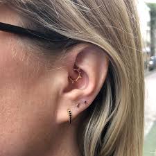 kanpatha on instagram daith piercing and high lobe piercing with yg moon and yg prong with black stone lobe piercing daith piercing black stone