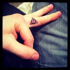 My Deathly Hallows Finger Tattoo Done By Alex Candela All 1 Tribe Market Harbourgh Uk Tattoos Finger Tattoos Harry Potter Tattoos