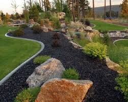 Cement Edging Black Rocks And Larger Rocks In With Plants Landscaping With Rocks Rock Garden Landscaping River Rock Landscaping