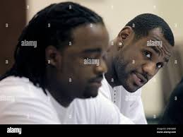 Cleveland Cavaliers LeBron James, right, looks around his former high  school teammate Willie McGee while talking with reporters in his old high  school gym at Akron St. Vincent-St. Mary High School on