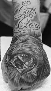 The grayscale themed tattoo makes the design look mysterious and fearless. Black And Grey Realism Lion Hand Tattoo Lion Hand Tattoo Lion Hand Tattoo Men Tiger Hand Tattoo