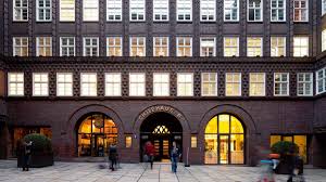 People walk outside the modern hamburg airport. The Building Chilehaus