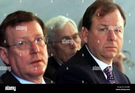 Mr Michael Graff (right)) President and chief operating officer of  Bombardier Aerospace, Northern Ireland First Minister David Trimble (left)  and Second Minister Seamus Mallon (back) listen to the announcement of  1,200 new