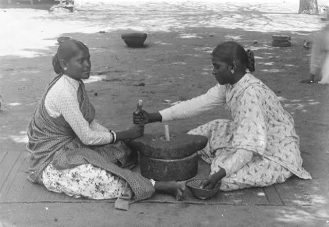 Indian Women grinding flour using Chakki – a typical grinder made of coarse stone. – Vintage India Photos