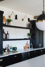 Black And Gold Kitchen Tiles Black And Gold Swing Arm Sconces Are Mounted To White Subway Backsplash Tiles Above Black Stacked F Kitchen Tiles Design Floating Shelves Kitchen Kitchen Tiles