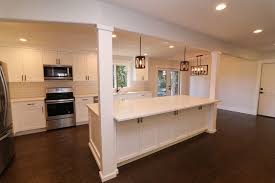 The emerald green and blue spanish tiles adds a unique and elegant pattern on the backsplash, adding a pop of color and movement with its elegant pattern. Custom Kitchen Island With Columns Farmhouse Kitchen Portland By Kamanski Construction Inc Houzz