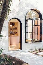 The Exterior Is Clad In Stucco A Material Commonly Used In The Area But The Steel Arched Window And Doo Art Deco Interior Art Deco Home Contemporary Art Deco