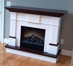 Perhaps a mantle is a way to punch up its look. White Concrete Fireplace Surrounds Ideas With Oak Mantel Mantels Fireplace Hearth Ideas Firep Wood Fireplace Surrounds Fireplace Mantel Designs White Fireplace
