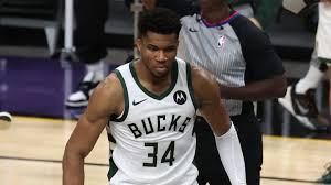 Milwaukee bucks forward giannis antetokounmpo reacts while holding the nba championship trophy, left, and most valuable player trophy after defeating the phoenix suns in game 6 of basketball's nba. Z Xzfwosaoldrm