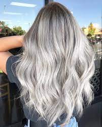 Long blonde grey hair with waves and a cool hair cut. 24 Best Silver Blonde Hair Colours To Try In 2020