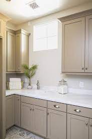 Check spelling or type a new query. Light Brown Shaker Cabinets Accented With Satin Nickel Cup Pulls And A White Quartz Countertop Are Fi Beige Kitchen Taupe Kitchen Cabinets Tan Kitchen Cabinets