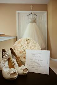 A luxurious wedding dress hangs on a hanger. Classically Glamorous New Jersey Wedding Modwedding Romantic Wedding Photos Wedding Picture Poses Wedding Shots