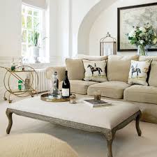 Founded on gleaming legs, this coffee table has two cylindrical ottomans with padded seats slide out from under the table when you need an extra seat. St Just Taupe Padded Coffee Table Footstool