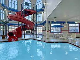 Indoor Pool Waterslide Hot Tub And Steam Room At The Ramada Brooks In Brooks Alberta Indoor Pool Indoor Waterpark Water Slides