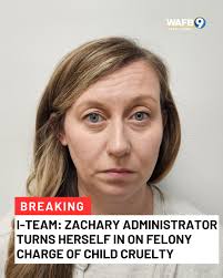 A school administrator in Zachary turned herself in to the East Baton Rouge  Parish jail Monday morning, according to jail records.