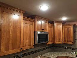 Staining your cabinets an unexpected color is a terrific way to put a custom touch on your kitchen cabinetry. Pecan Cabinets With Crown Molding And Quartz Countertops Kitchen Remodel Kitchen Design Kitchen
