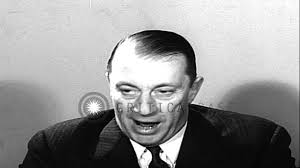 Graham McNamee, seated at a desk, congratulates City of Cleveland, Ohio,