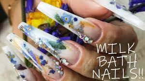 Kirsty Meakin Of Naio Nails Shows How To Create The Popular Milk Bath Nail Design Using Real Flowers Nail Art Tutorial Milk Bath Acrylic Nails