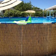 How Cute And Islandy Is This P Above Ground Pool Disguised With Bamboo Pool Landscaping In Ground Pools Above Ground Pool