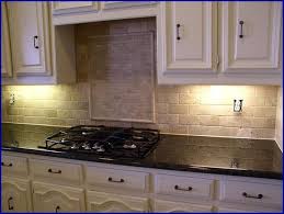 Beautiful kitchen with white cabinets with ubatuba granite countertops and subway tile backsplash, sink in oversized kitchen island, stacked stainless steel dishwashers in kitchen island, stainless steel kitchen hood over wolf range, double ovens, recycled glass vases and iron chandelier. Kitchen Tile Backsplash Ideas With Uba Tuba Granite Countertops Jpg 646 4 Kitchen Design Diy Kitchen Countertops Granite Backsplash Kitchen Remodel Countertops