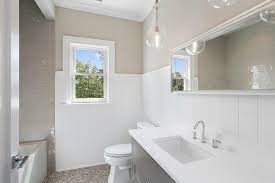 Opt for neutral bathroom colors, such as crisp white, cool gray, and rich brown, for a beautifully birch woods wallpaper in shades of taupe inspired the color palette for this powder room redo. Taupe Bathroom Walls Design Ideas