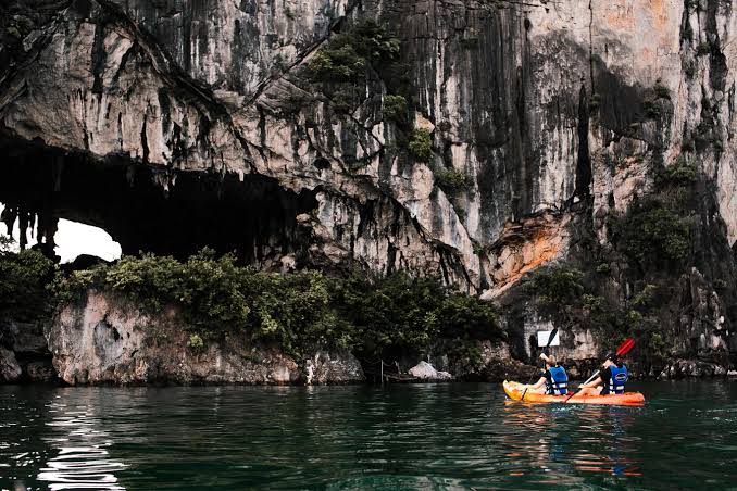 People Kayaking near a Limestone Karst in Ha Long Bay · Free Stock Photo