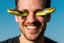 Man lifting large snakehead fish in traditional loincloth