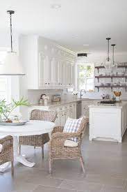 Round table eat in kitchen. White Round Dining Table With Wicker Dining Chairs Transitional Kitchen