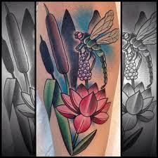 Here's another amazing work of a lotus flower tattoo paired with a colorful dragonfly this time. Trustworthy Tattoo