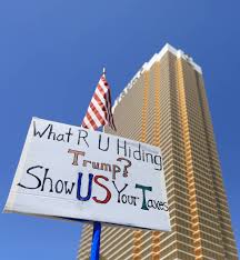 a demonstrator hold a sign asking president donald trump to release his tax returns during a ta las vegas review journal asking president donald trump