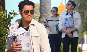 Henry golding tied the knot to his girlfriend turned wife liv lo. Henry Golding Looks Every Bit The Doting Dad While Strolling With Wife Liv Lo And Newborn In Venice Daily Mail Online