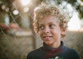 It's also sure to attract a lot of positive attention on boys of all ages. Young Boy With Blonde Curly Hair Stock Photo Offset