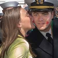 Ensign Jonathan Wheeler, assigned to the gold crew of the ballistic missile  submarine USS Alaska (SSBN 732), receives a kiss during the Savannah St.  Patrick's Day Parade.