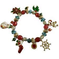 Christmas Charm Bracelet With Snowman Stocking Snowflake Candy Canes Holly And Poinsettia Flower Www Ruby Charm Bracelet Christmas Charms Poinsettia Flower