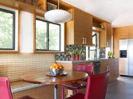 A window is placed behind the gas range so the owner can look outside to the wild yard while cooking. Open Kitchen With Large Island Novocom Top