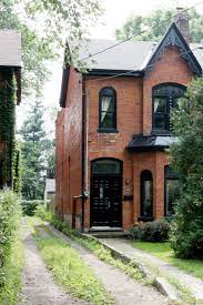 The house next door is an identical cottage; Red Brick Houses With Black Trim Design Indulgence