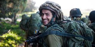 Handsome idf soldier smiles while reading psalms, wrapping teffillin. In Support Of Our Soldiers Non Profit Organizations For Lone Idf Soldiers Talknsave